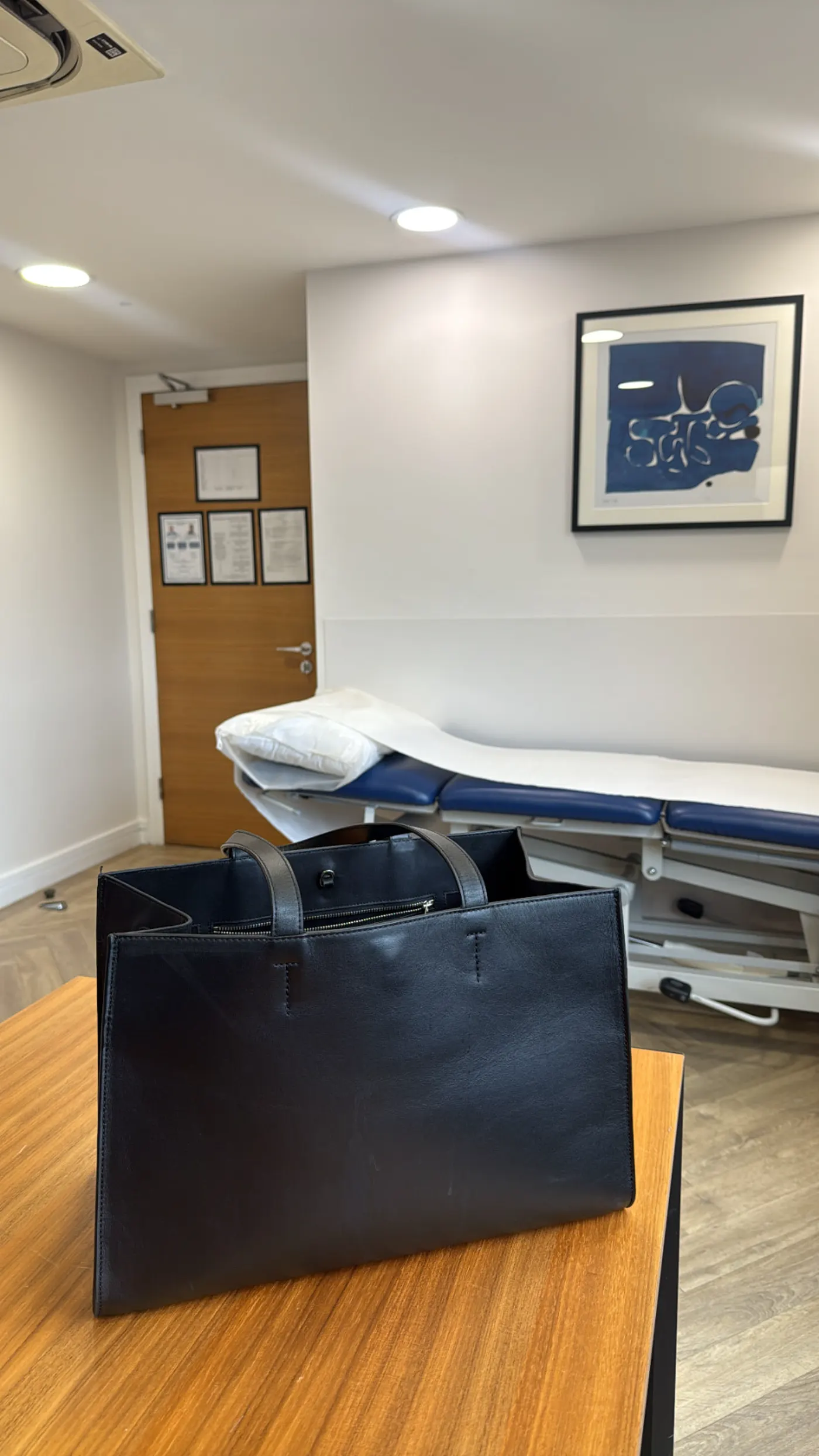 Examination couch and doctor's bag in a Deia Health consulting room